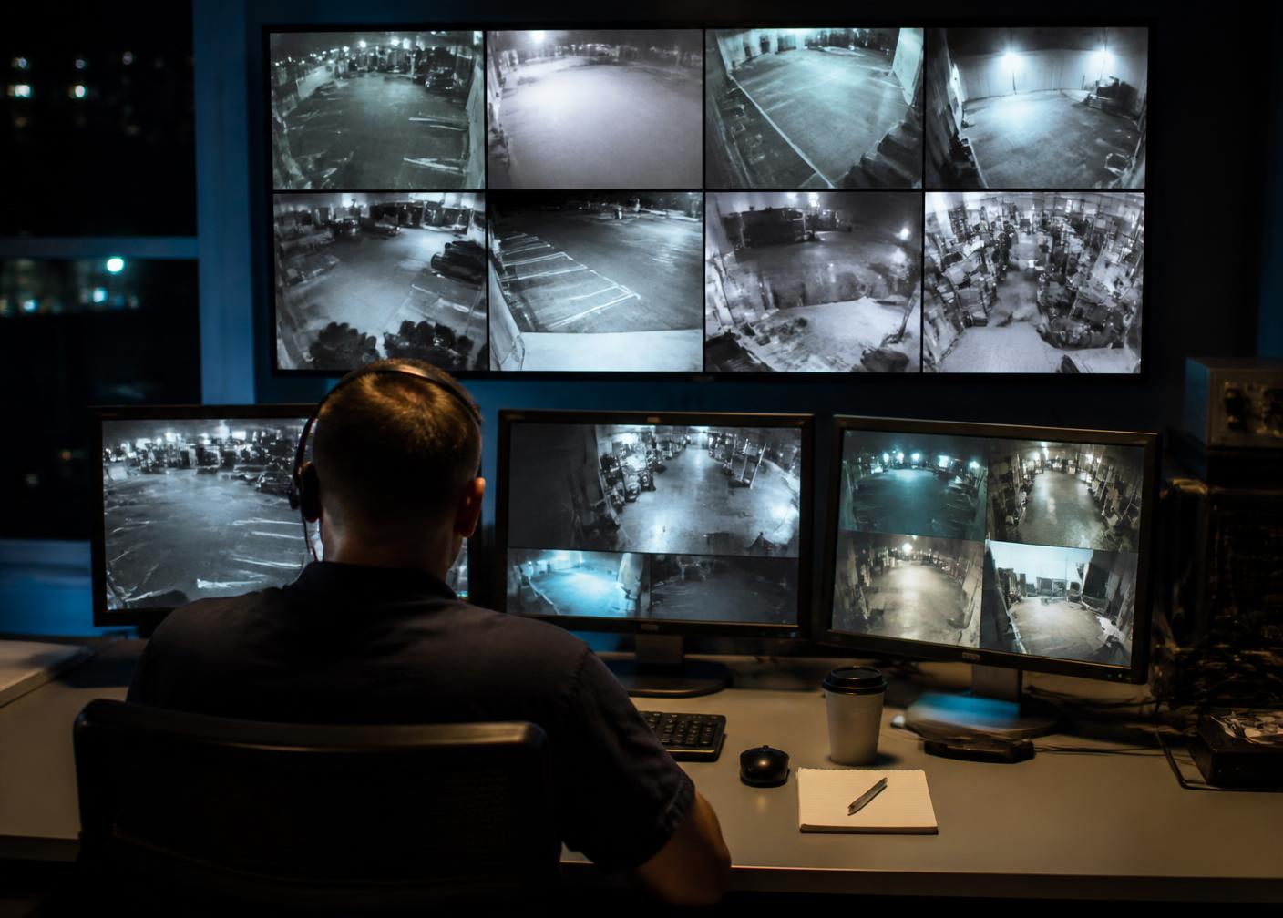 Meridian operator monitoring live CCTV feeds in the control room at night