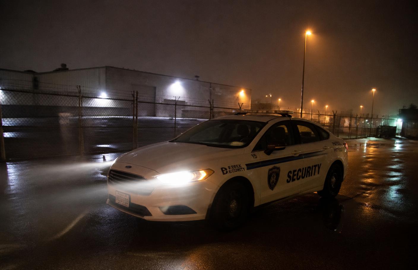 Marked Meridian patrol vehicle on a misty industrial yard at night
